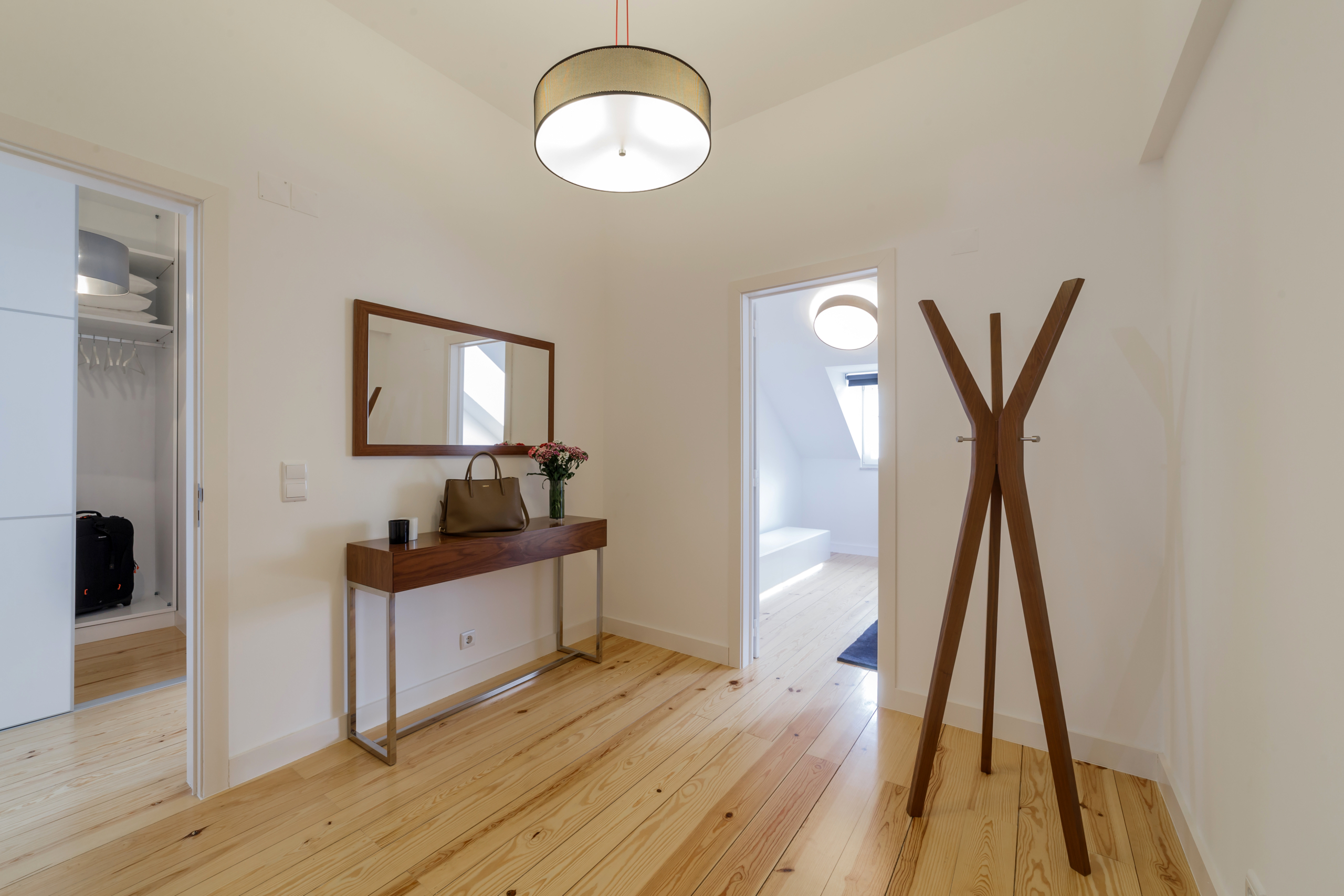 Modern apartment with white walls and light wooden floor Central apartment with doorman